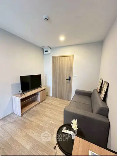 Modern living room with sleek furniture and TV, perfect for cozy relaxation.