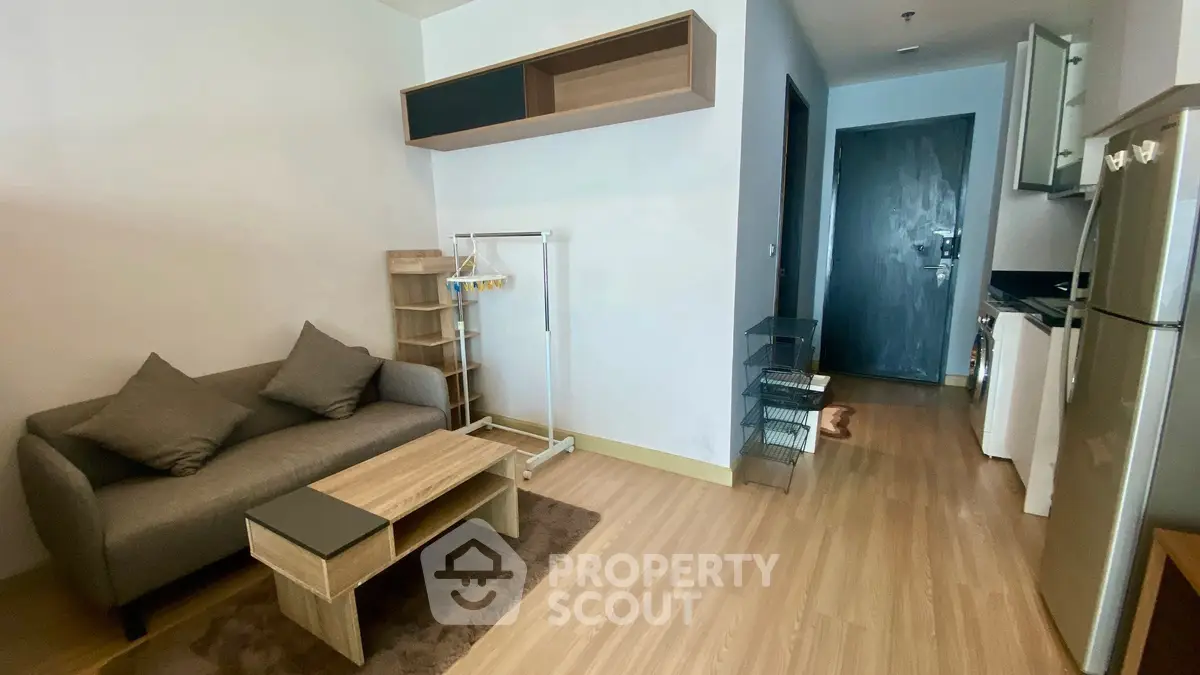 Cozy modern living room with compact kitchen and stylish furniture