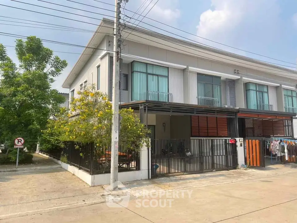 Modern two-story house with sleek design and spacious outdoor area in a serene neighborhood.