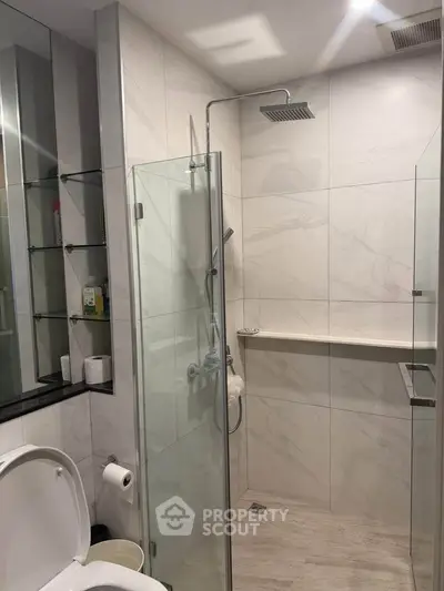 Modern bathroom with glass shower enclosure and sleek fixtures