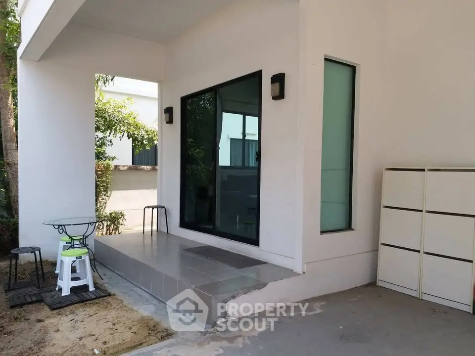 Modern minimalist exterior with sleek design and outdoor seating area, perfect for relaxation.