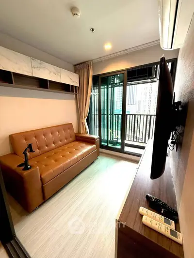 Modern living room with leather sofa and balcony view in urban apartment