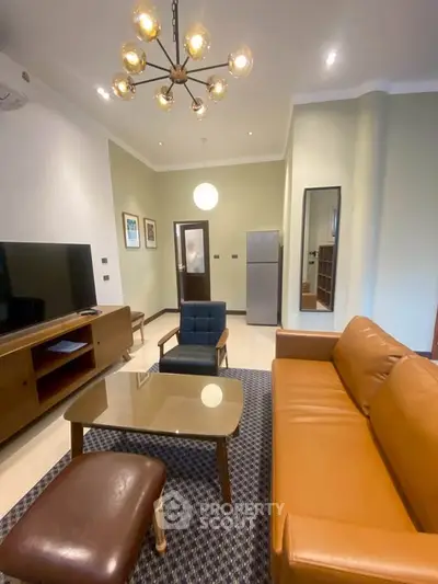 Stylish living room with modern furniture and elegant lighting in a cozy apartment.