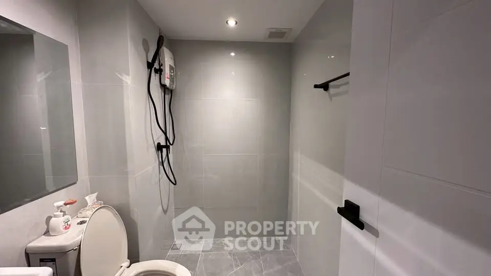 Modern bathroom with sleek gray tiles and shower area