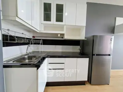 Modern kitchen with sleek cabinets and stainless steel fridge