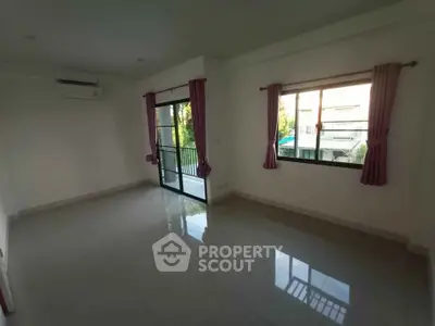 Spacious living room with large windows and balcony access in modern apartment