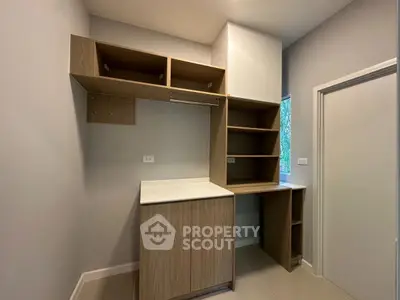 Modern storage room with sleek wooden cabinetry and natural light.