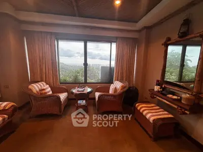 Cozy living room with wicker furniture and scenic window view