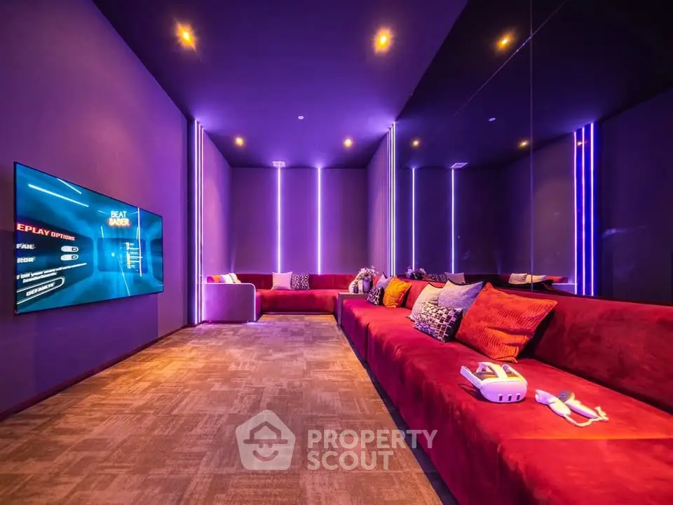 Luxurious entertainment room with vibrant lighting and plush seating, perfect for gaming and relaxation.