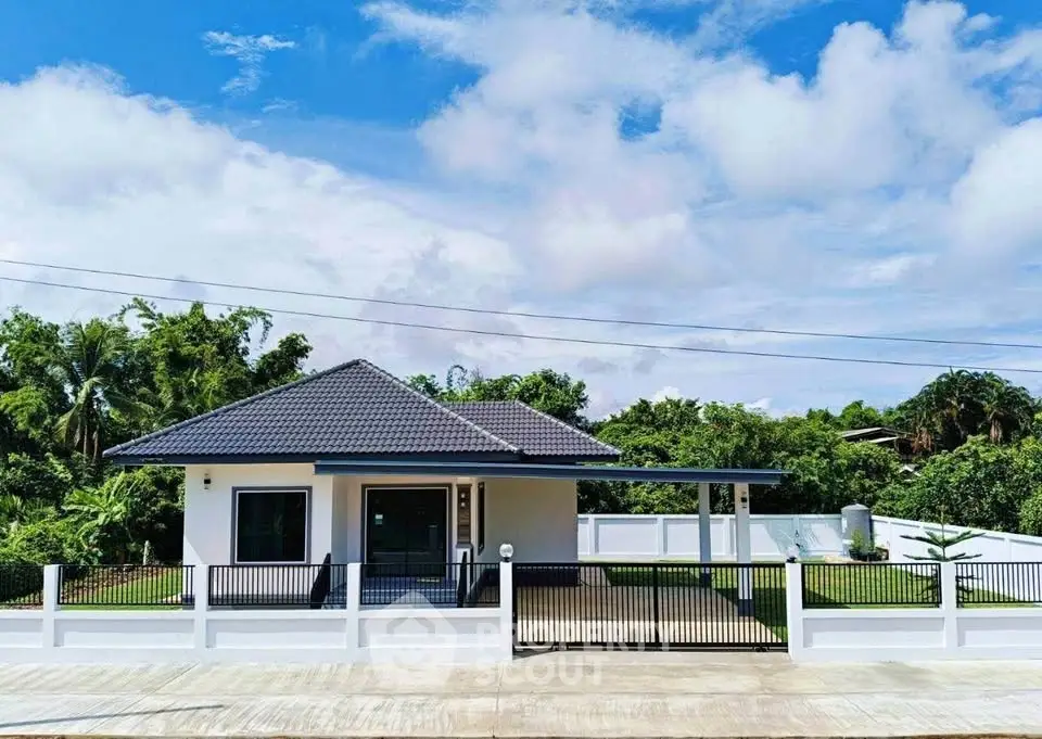 Charming single-story home with modern design and lush greenery, perfect for serene living.