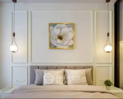 Elegant bedroom with modern lighting and floral artwork, perfect for a cozy retreat.