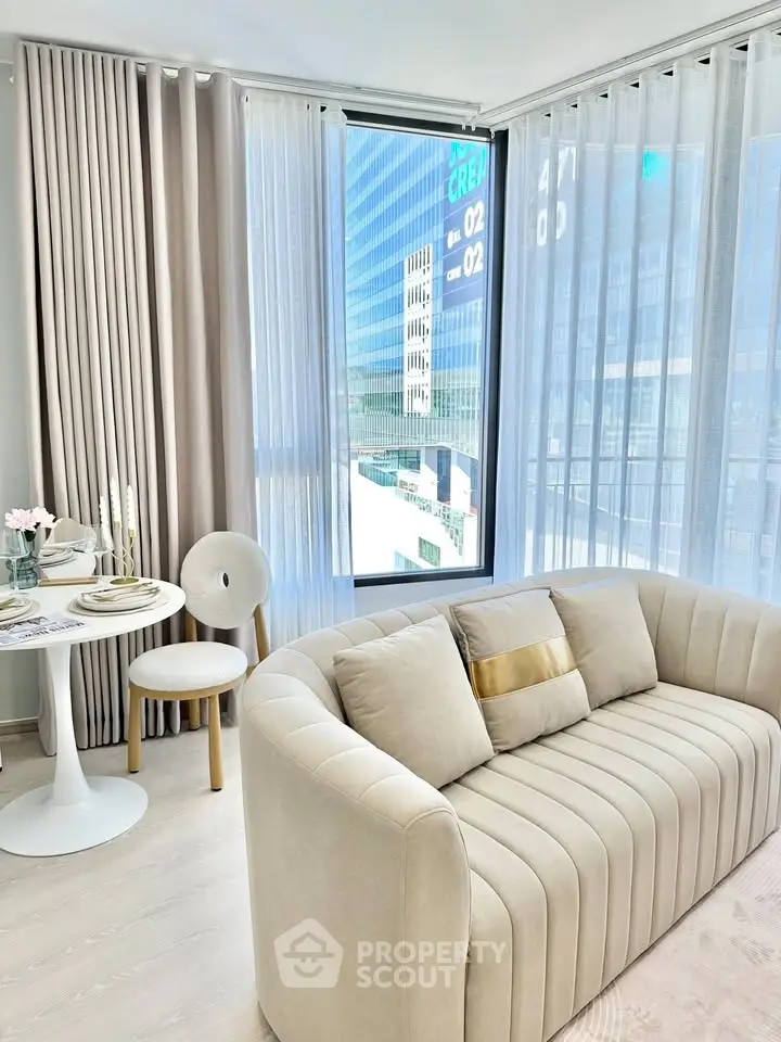 Modern living room with elegant beige sofa and city view, perfect for urban living.