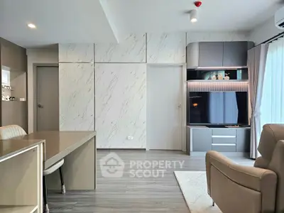 Modern living room with sleek design, featuring a large TV, elegant furniture, and stylish decor.