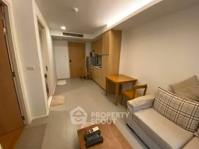 Cozy living room with modern kitchenette in a compact apartment