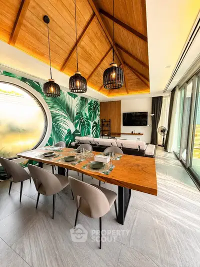 Luxurious living room with tropical decor, high wooden ceiling, and elegant dining area.