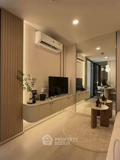 Modern living room with stylish decor and air conditioning, featuring a cozy seating area and elegant lighting.