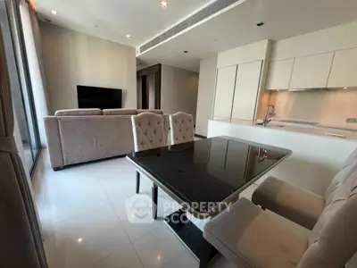 Modern open-plan living room with sleek kitchen and elegant dining area