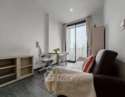 Modern living room with balcony view, featuring sleek furniture and natural light.