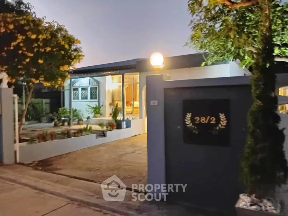 Charming single-story home with inviting entrance and well-maintained garden, perfect for cozy living.