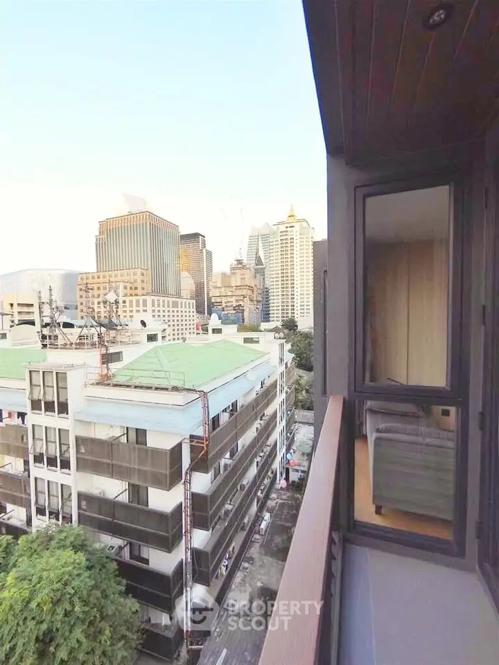 Stunning city view from a high-rise balcony overlooking urban skyline.