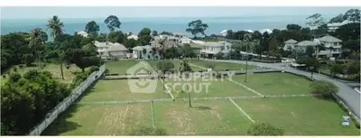 Stunning coastal property with lush greenery and ocean views, perfect for luxury development.