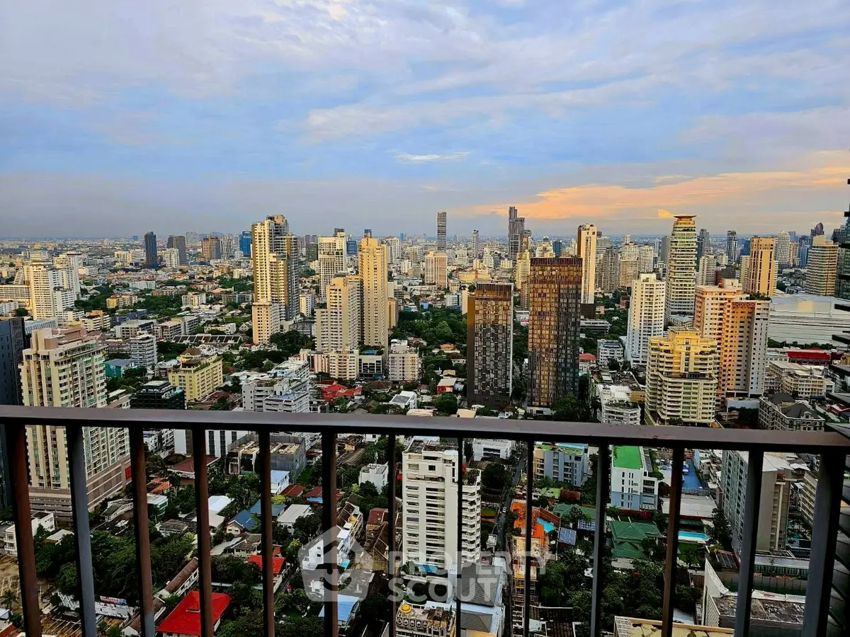 Stunning cityscape view from high-rise balcony at sunset