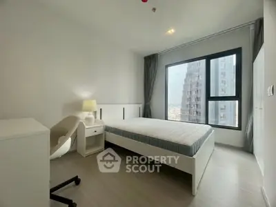 Modern minimalist bedroom with large window and city view