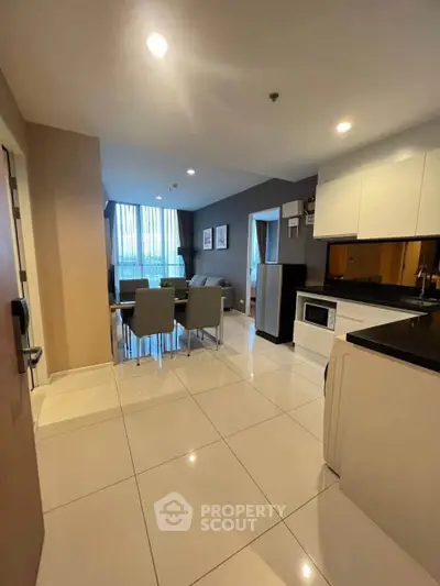 Modern open-plan kitchen and dining area with sleek design and natural light.