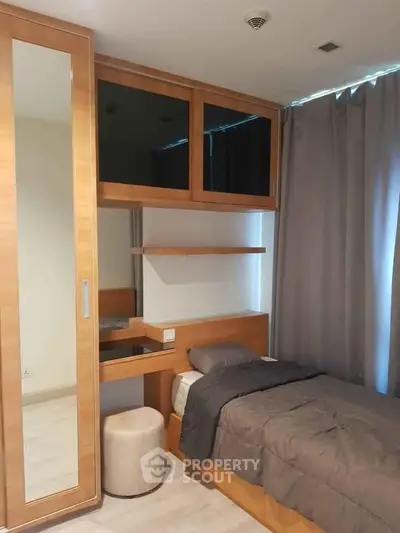 Cozy bedroom with modern wooden furniture and elegant gray curtains