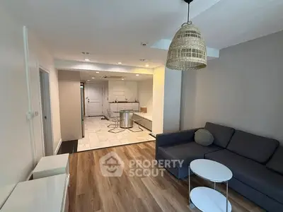 Modern open-plan living room with stylish decor and cozy seating area.