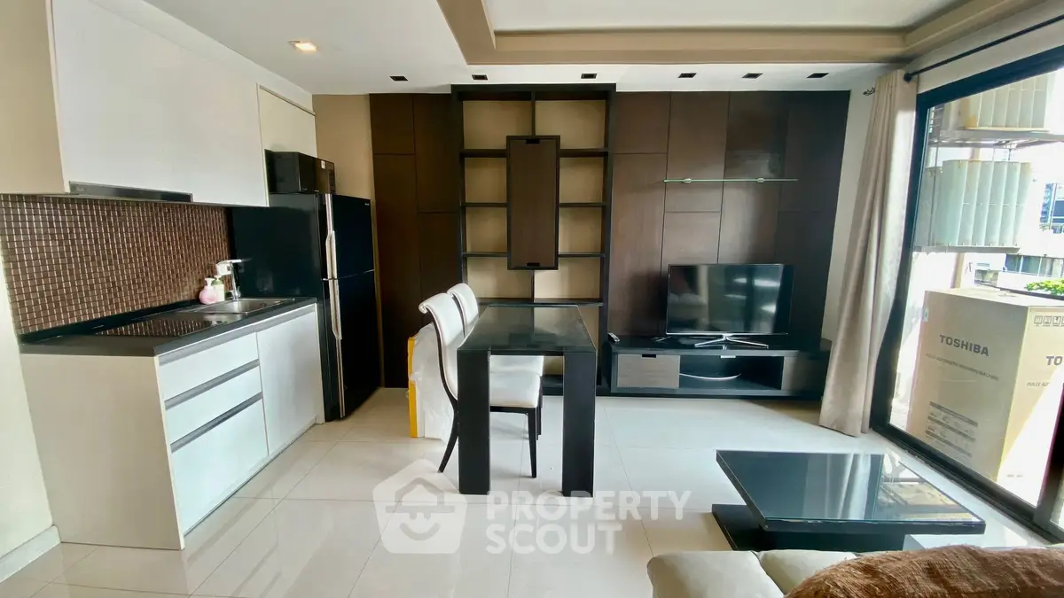 Modern open-layout living room with sleek kitchen and stylish decor