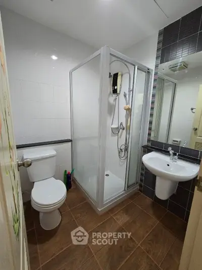 Modern bathroom with shower cabin and sleek fixtures in a contemporary apartment.