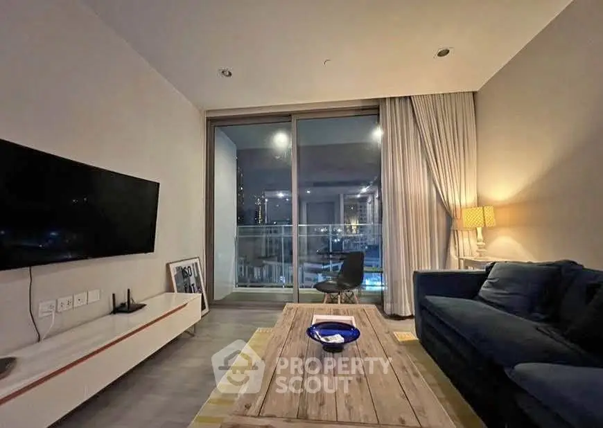Modern living room with cozy seating and large window view