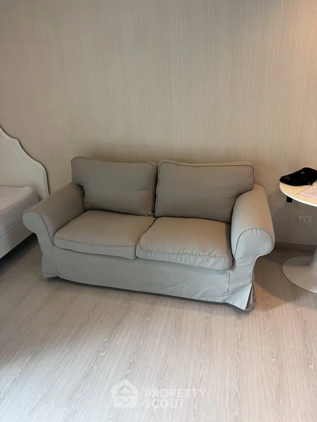 Cozy living room with a stylish gray sofa and modern side table, perfect for relaxation and comfort.