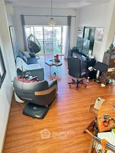 Spacious living room with modern furniture and balcony access