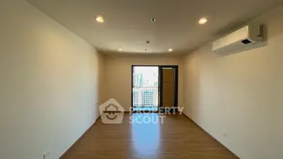 Spacious unfurnished room with balcony and city view, perfect for customization.