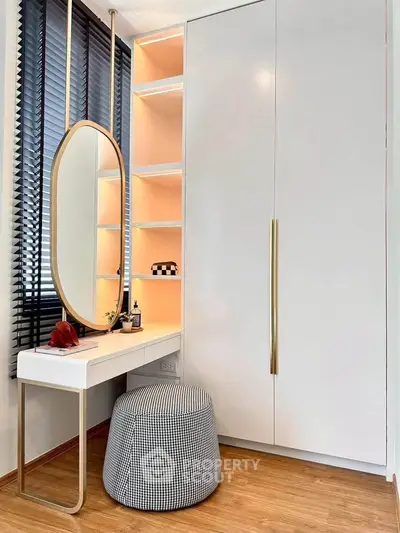 Stylish modern bedroom corner with sleek wardrobe and elegant vanity mirror.