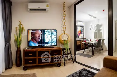 Modern living room with stylish decor and open view to dining area, featuring air conditioning and wooden furniture.