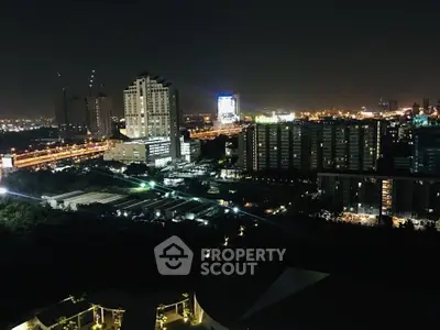 Stunning night cityscape view from high-rise building, showcasing vibrant urban lights and skyline.