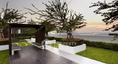 Stunning rooftop garden with modern design and city skyline view at sunset.