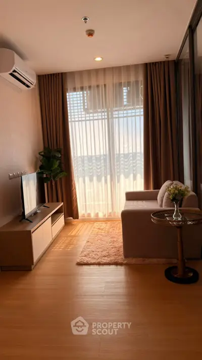 Modern living room with natural light, wooden flooring, and stylish furniture in a cozy apartment.