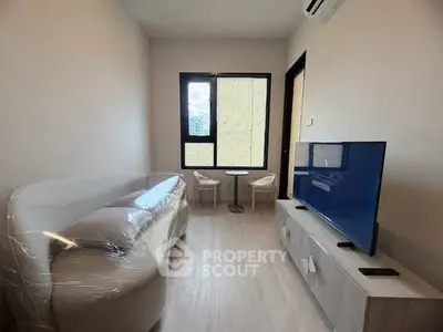 Modern living room with sleek furniture and natural light, perfect for cozy relaxation.