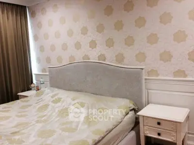 Cozy bedroom with elegant wallpaper and classic furniture design.