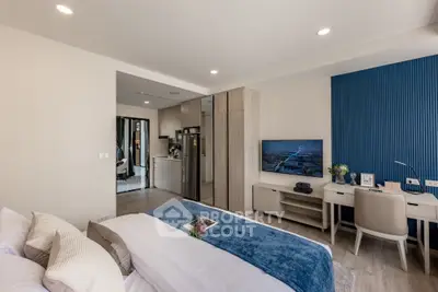 Modern bedroom with stylish decor and integrated study area, featuring sleek furniture and contemporary design.