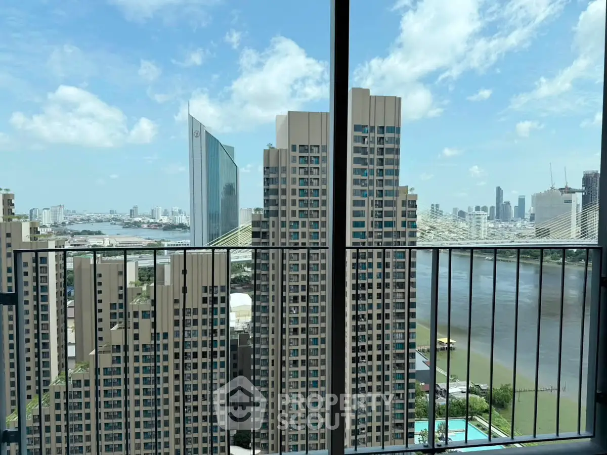 Stunning high-rise view from balcony overlooking river and city skyline