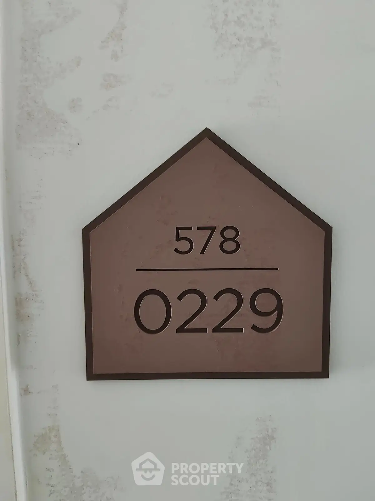 Modern apartment number sign with minimalist design