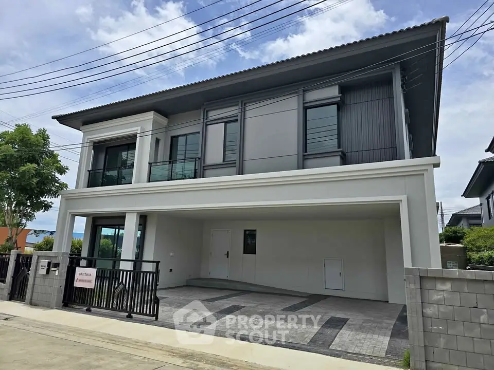 Modern two-story house with spacious driveway and sleek exterior design