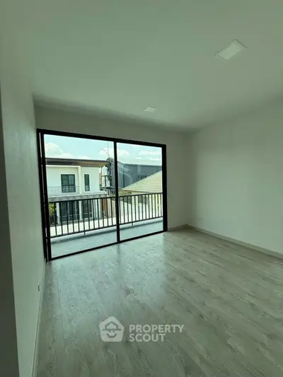 Spacious modern room with large windows and balcony view, perfect for natural light lovers.