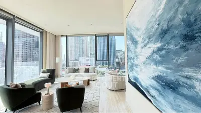 Luxurious modern living room with stunning city view and elegant decor.