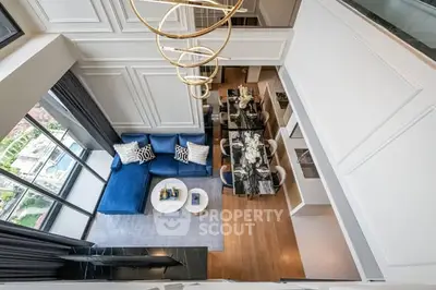 Luxurious modern living room with elegant decor and stunning city view from above.